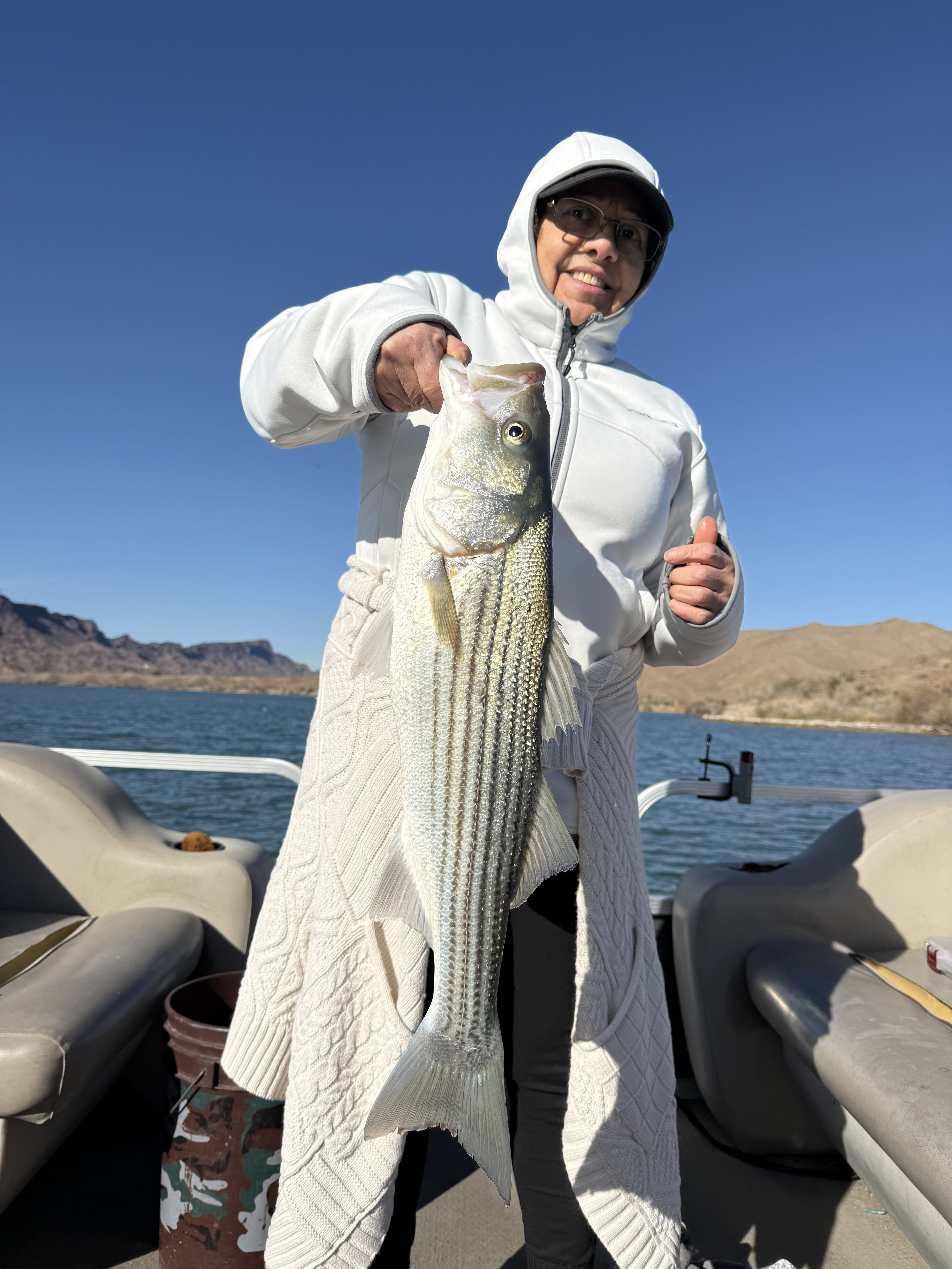 Group photo of anglers holding striped bass